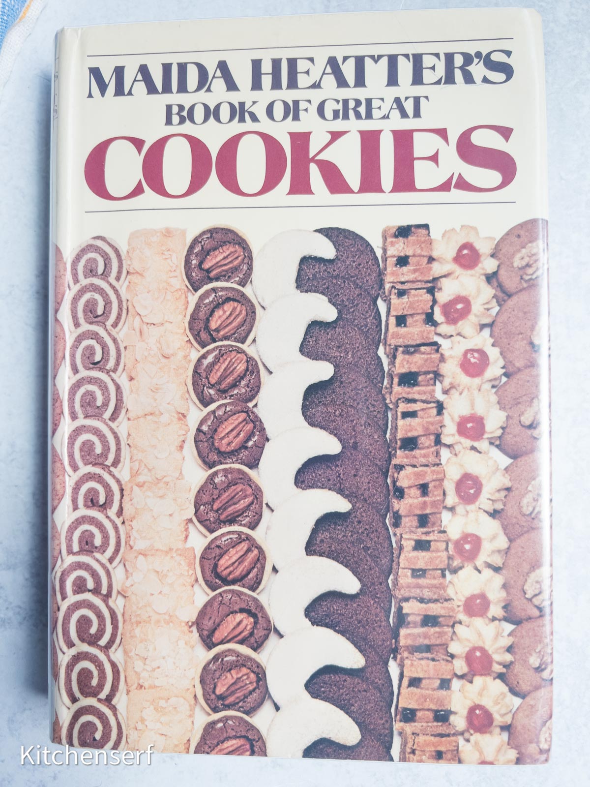 Cover of Maida Heatter’s Book of Great Cookies, one of the most beloved baking books, featuring rows of assorted cookies displayed vertically.