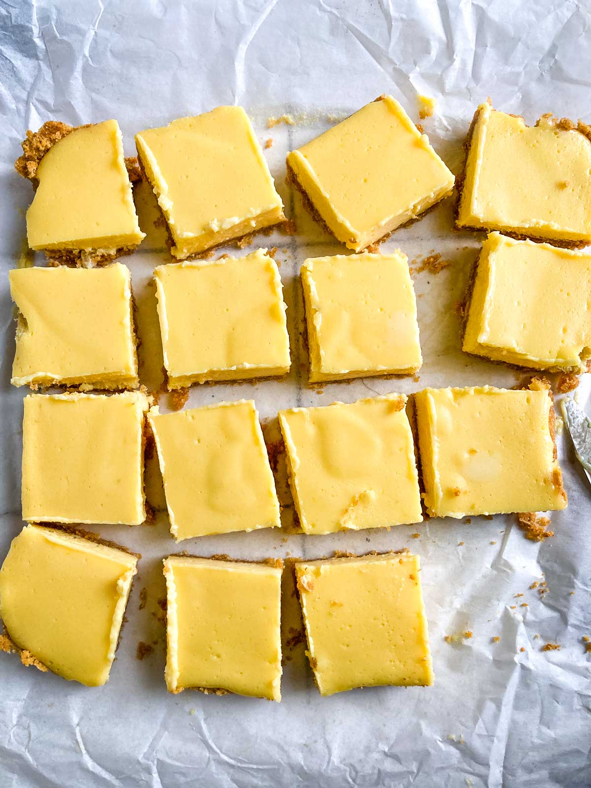 lemon bars on parchment paper