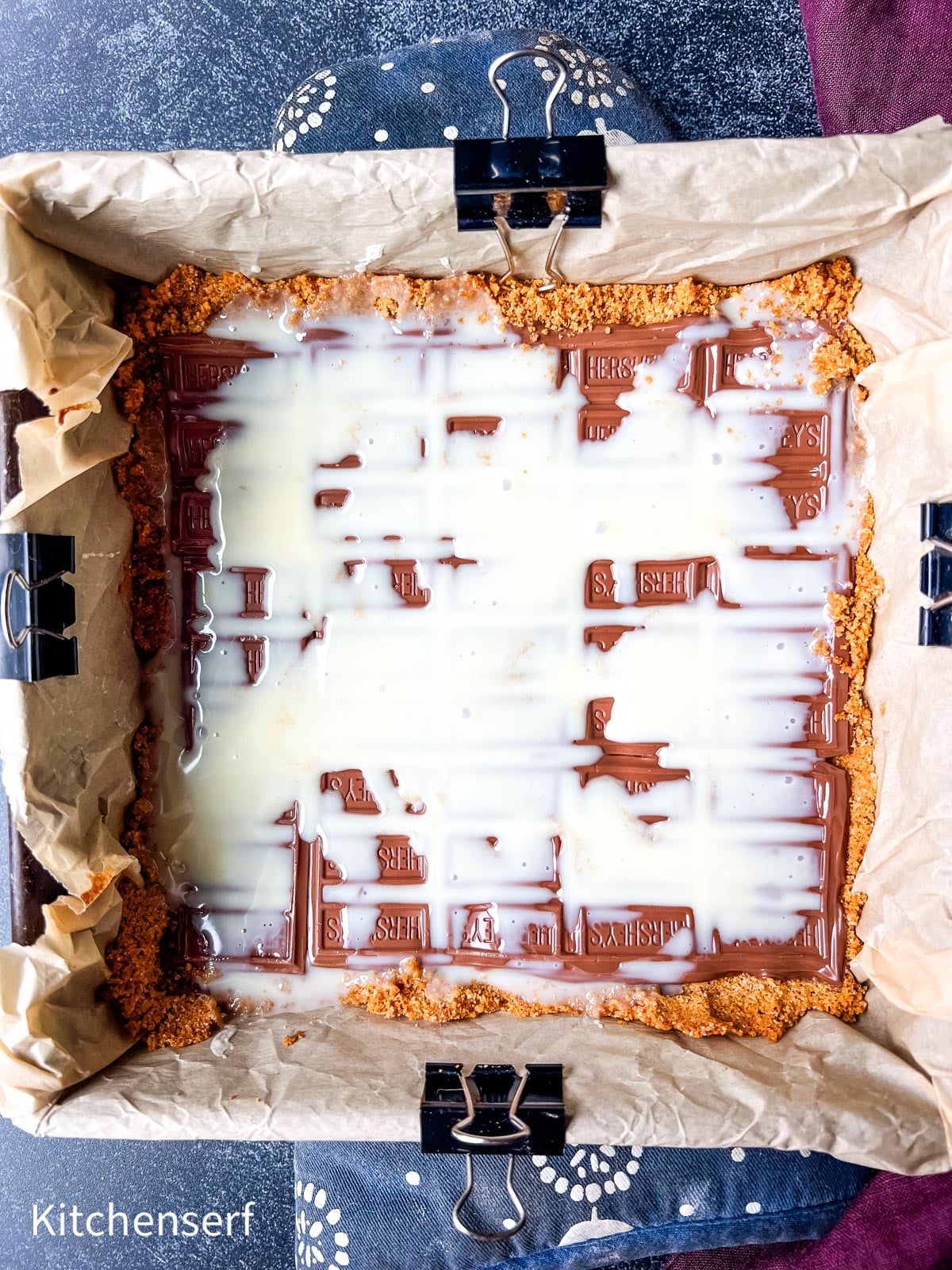 Pan lined with parchment, filled with graham crust, Hershey’s chocolate bars, and drizzled sweetened condensed milk—these irresistible s’mores bars capture classic campfire flavor in every bite.