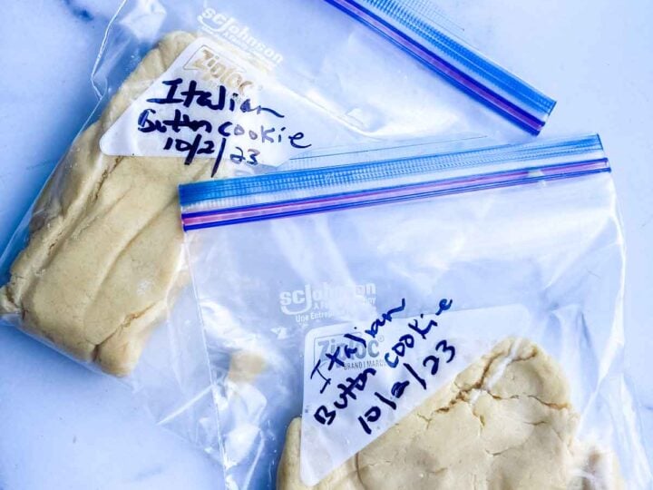 resealable freezer bags containing cookie dough on a marble countertop.