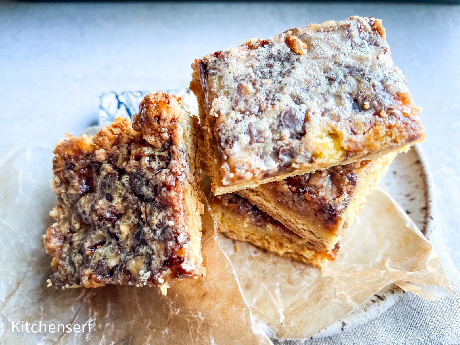Three cake mix toffee bars stacked on wax paper.