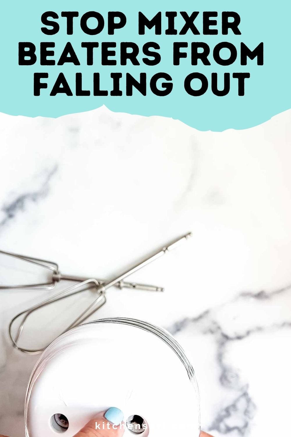 Hand mixer with detached beaters on a marble surface, showing how to stop mixer beaters from falling out.