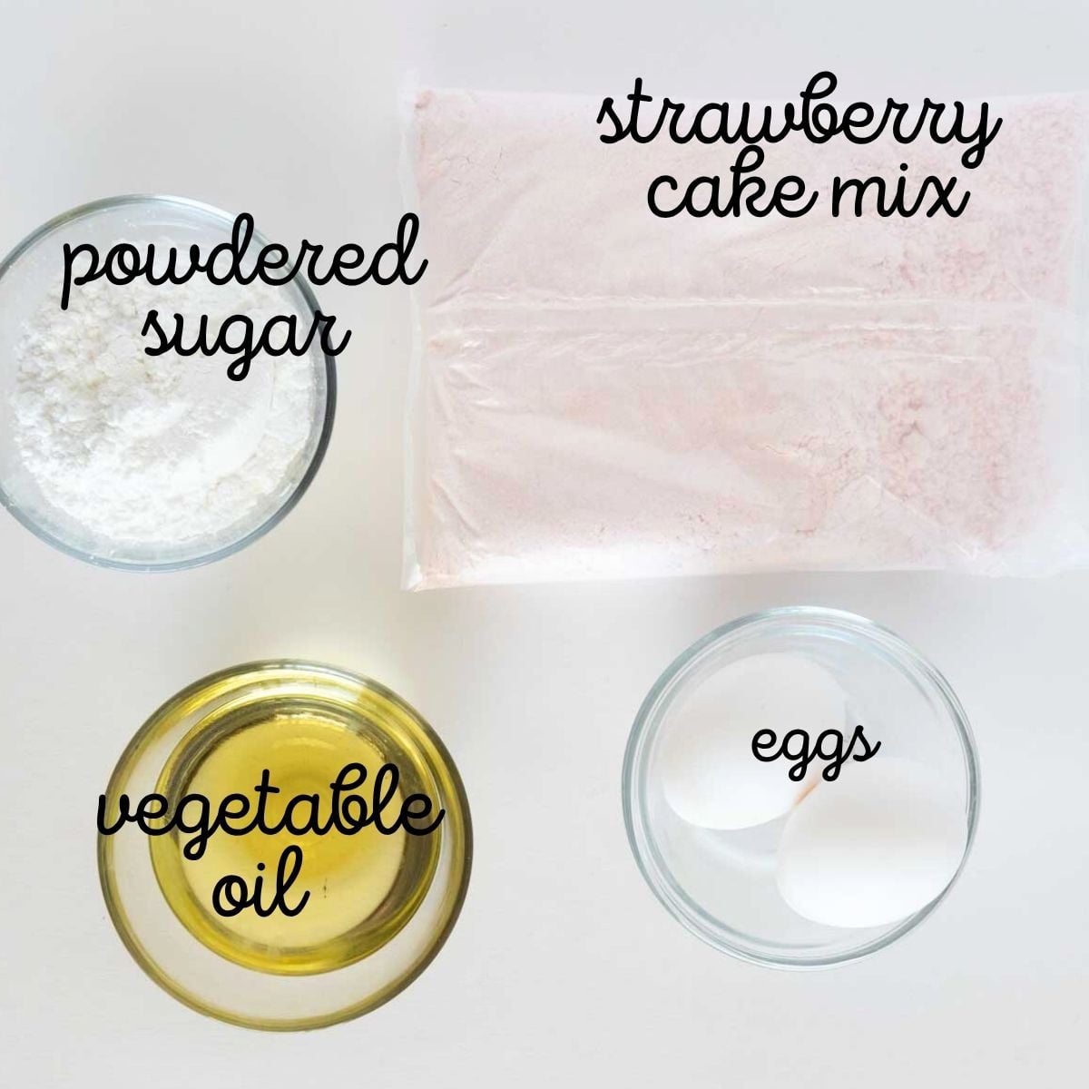 Four baking ingredients labeled: powdered sugar, strawberry cake mix, vegetable oil, and eggs on a white surface.